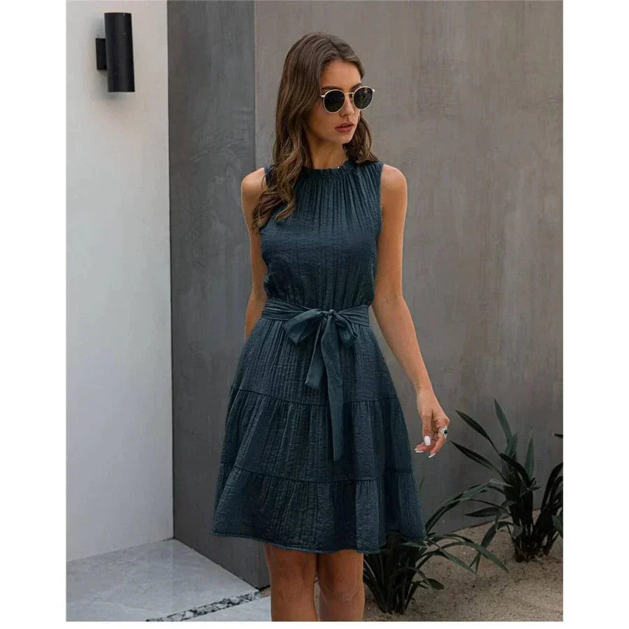 Back view of a woman wearing the Leah Women's Sleeveless Dress, a short dress with a flowy, tiered skirt, perfect for casual or semi-formal occasions.