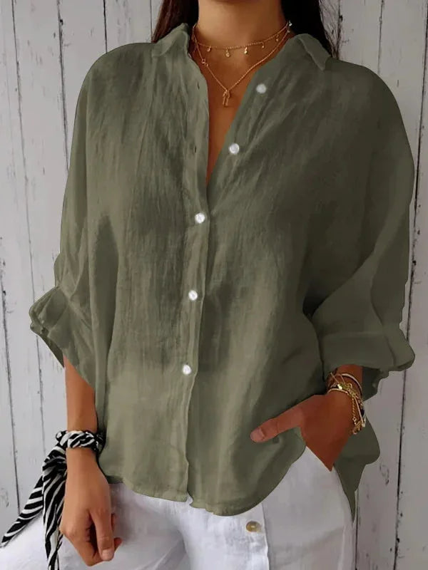 A relaxed-fit women's blouse with a button-up front, long sleeves, and a lightweight, flowy design, styled casually for versatile wear.
