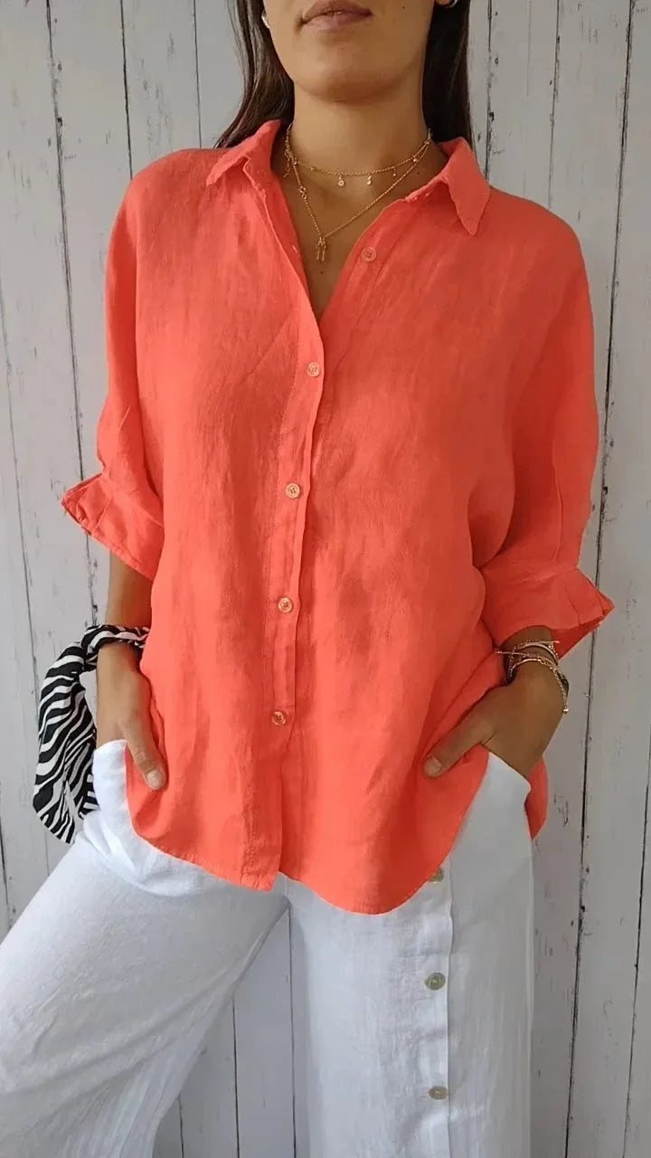 A relaxed-fit women's blouse with a button-up front, long sleeves, and a lightweight, flowy design, styled casually for versatile wear.