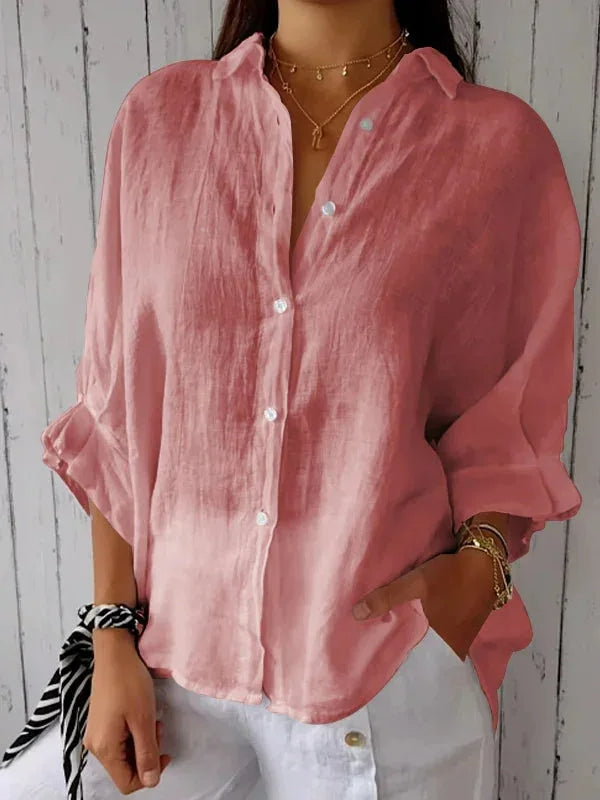 A relaxed-fit women's blouse with a button-up front, long sleeves, and a lightweight, flowy design, styled casually for versatile wear.