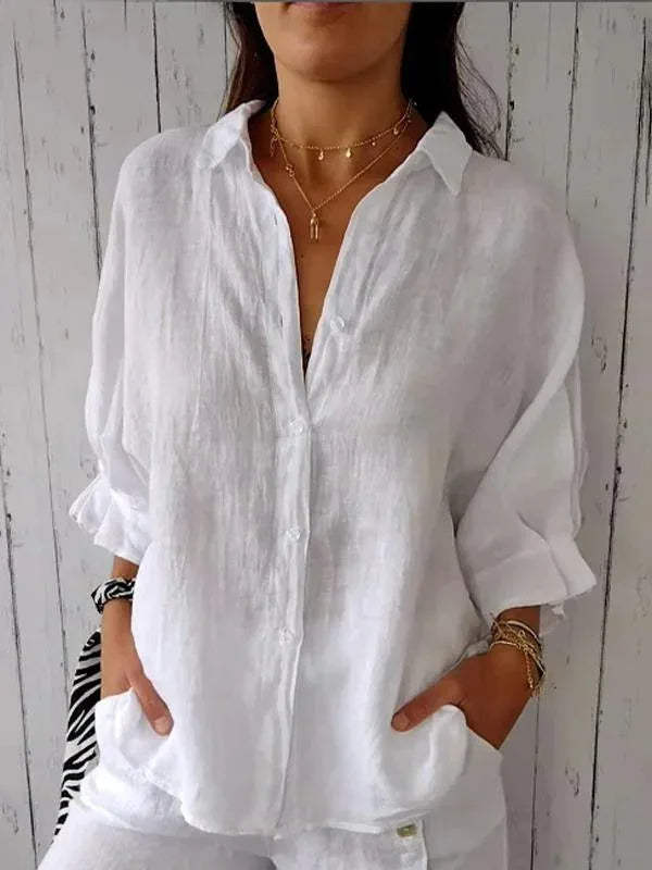 A relaxed-fit women's blouse with a button-up front, long sleeves, and a lightweight, flowy design, styled casually for versatile wear.