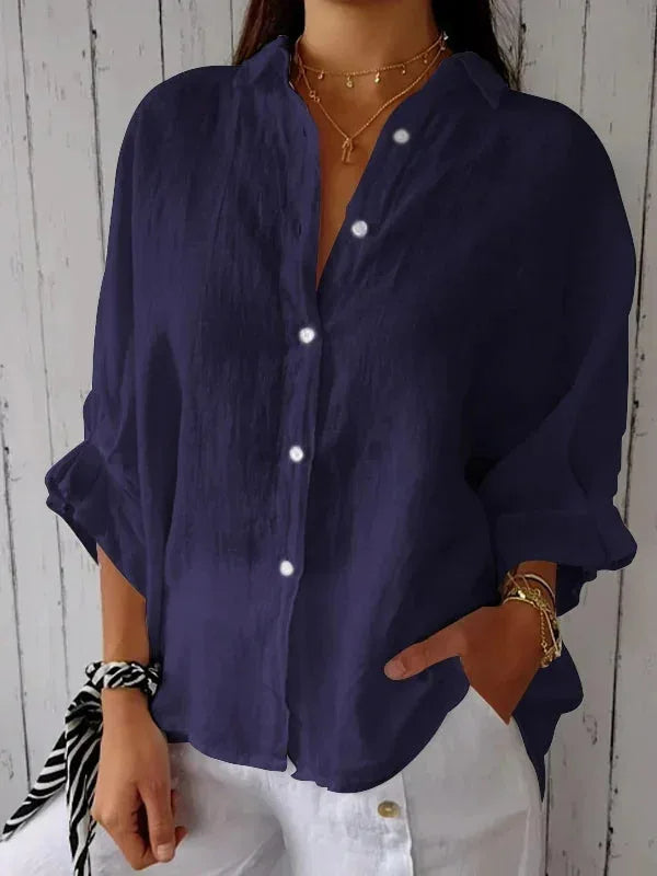 A relaxed-fit women's blouse with a button-up front, long sleeves, and a lightweight, flowy design, styled casually for versatile wear.