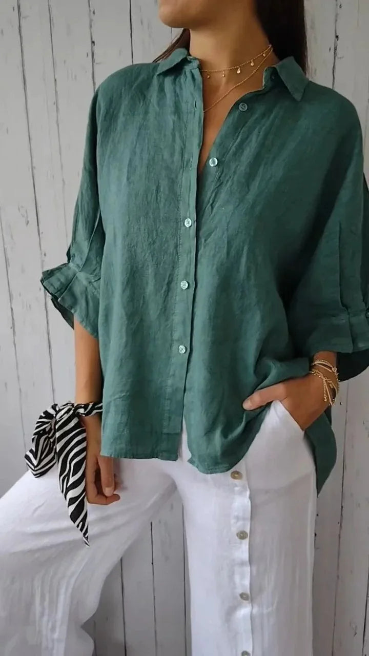 A relaxed-fit women's blouse with a button-up front, long sleeves, and a lightweight, flowy design, styled casually for versatile wear.
