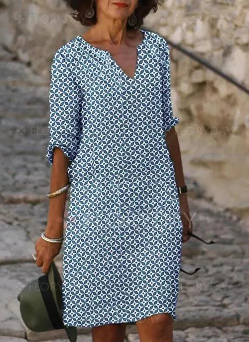 Woman wearing a patterned dress with a relaxed fit, featuring a stylish and comfortable design ideal for casual outings.