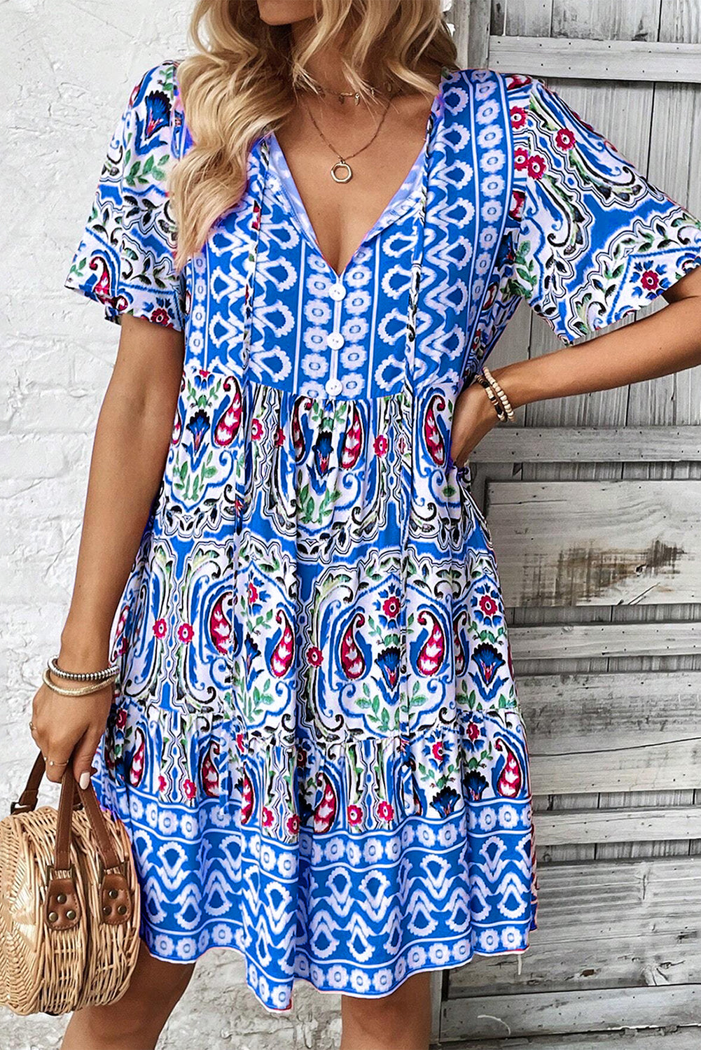 Model wearing the Sienna Women's Boho Print Dress, showcasing a relaxed fit and intricate bohemian-inspired patterns. The dress features a deep V-neckline, short sleeves, and a flowy, casual design ideal for warm-weather outings.
