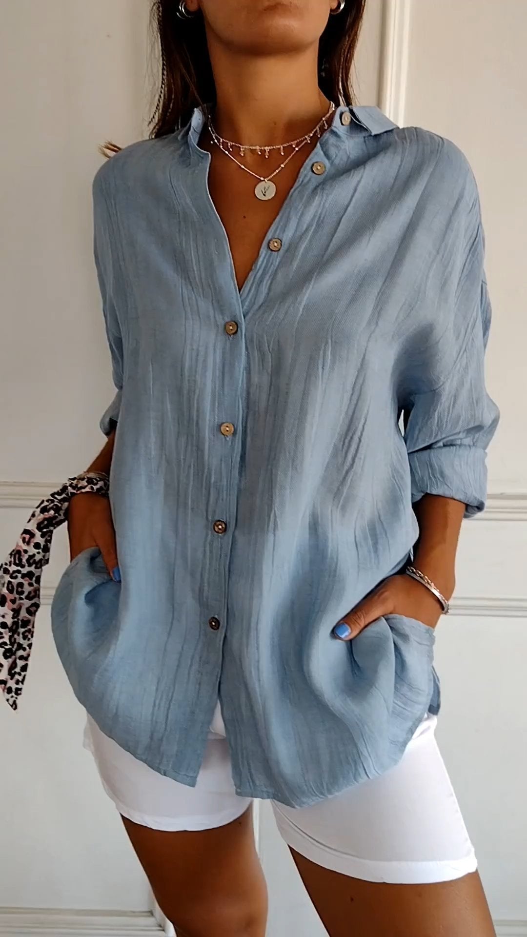 Stylish women's lightweight shirt with a relaxed fit, featuring button details and a casual, versatile design ideal for everyday wear.