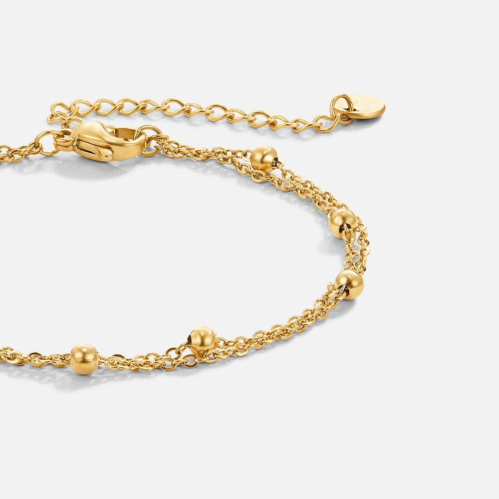 Smiling woman showcasing the Emily Women's Delicate Bracelet on her wrist, highlighting its minimalist design and elegant details. A perfect accessory for adding subtle sophistication to any outfit.
