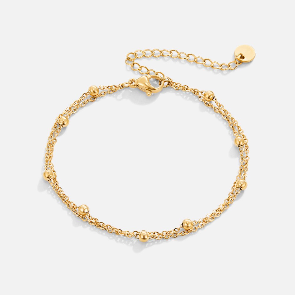 Smiling woman showcasing the Emily Women's Delicate Bracelet on her wrist, highlighting its minimalist design and elegant details. A perfect accessory for adding subtle sophistication to any outfit.