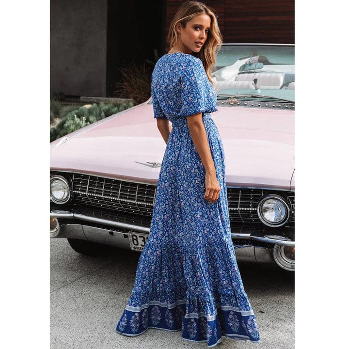 Woman wearing the Sabrina Women's Bohemian Maxi Dress, a flowing ruffled dress with a relaxed, bohemian style, posing gracefully in front of a classic car, exuding a free-spirited and elegant vibe.