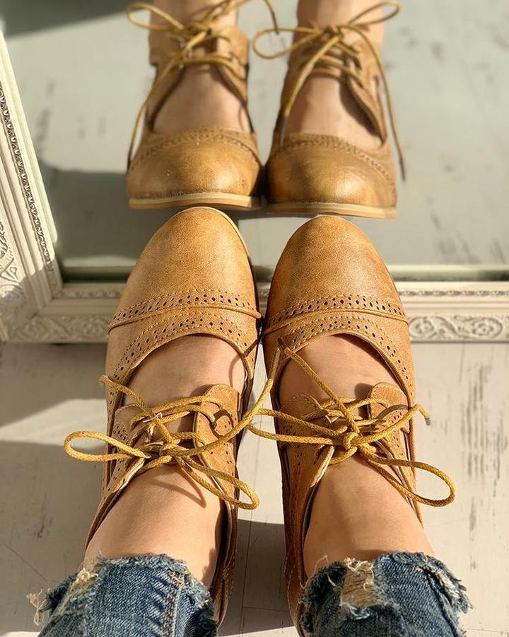 Elegant women's heeled shoes with lace-up detailing and a timeless design, paired with denim pants. Perfect for casual or formal occasions.