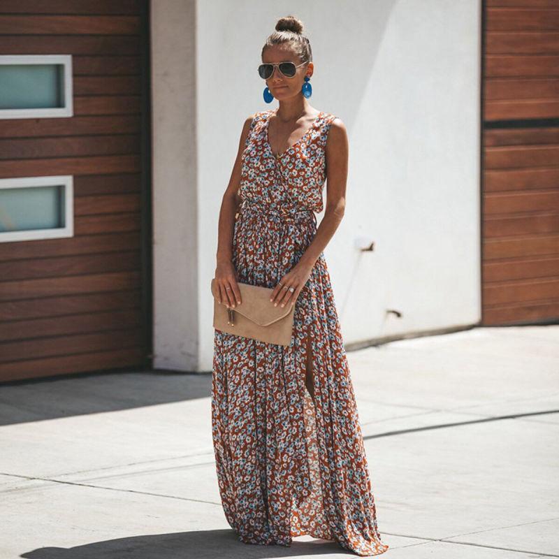 Woman wearing the Emily Women's Flowing Maxi Dress, a long, elegant dress with a flattering fit, accessorized with statement earrings, sunglasses, and a clutch bag, standing outdoors in a stylish, relaxed pose.