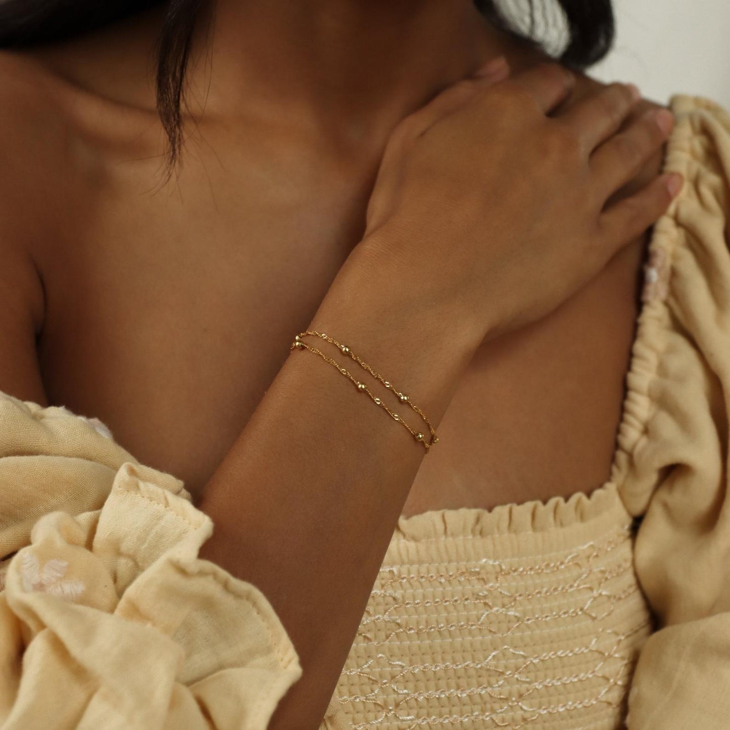 Close-up of a model wearing the Sofia Women's Delicate Bracelet, featuring a minimalist and elegant design, perfect for adding a subtle touch of sophistication to any outfit.