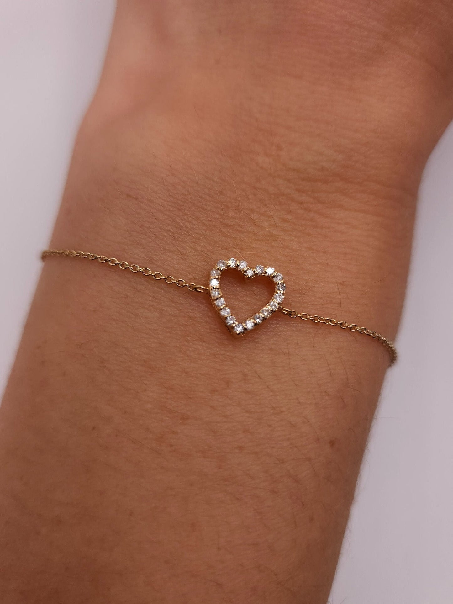 Close-up of the Lily Women's Heart Bracelet featuring a delicate heart-shaped design on the wrist. A charming and elegant accessory perfect for adding a romantic touch to any outfit.