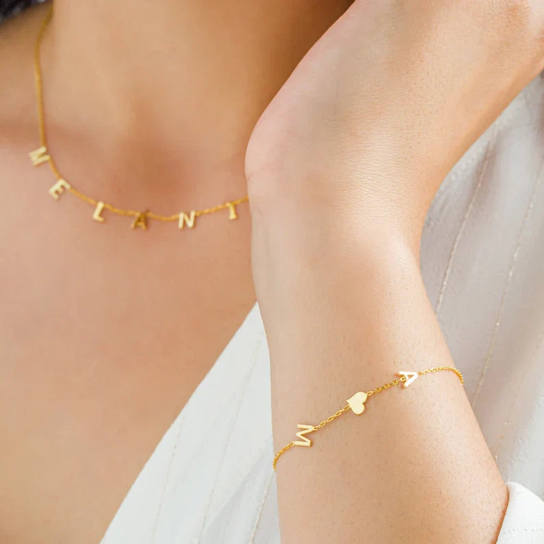 Close-up of a model wearing the Elena Women's Personalized Bracelet featuring a custom name design, paired with a matching personalized necklace for a chic and meaningful look.
