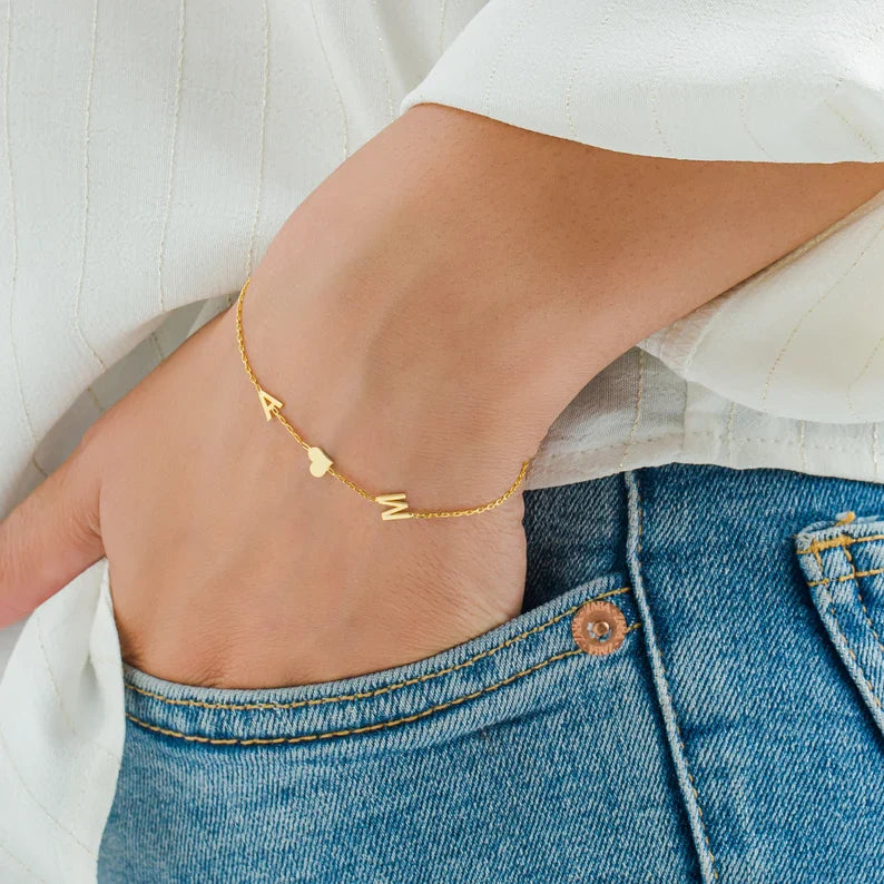 Close-up of a model wearing the Elena Women's Personalized Bracelet featuring a custom name design, paired with a matching personalized necklace for a chic and meaningful look.