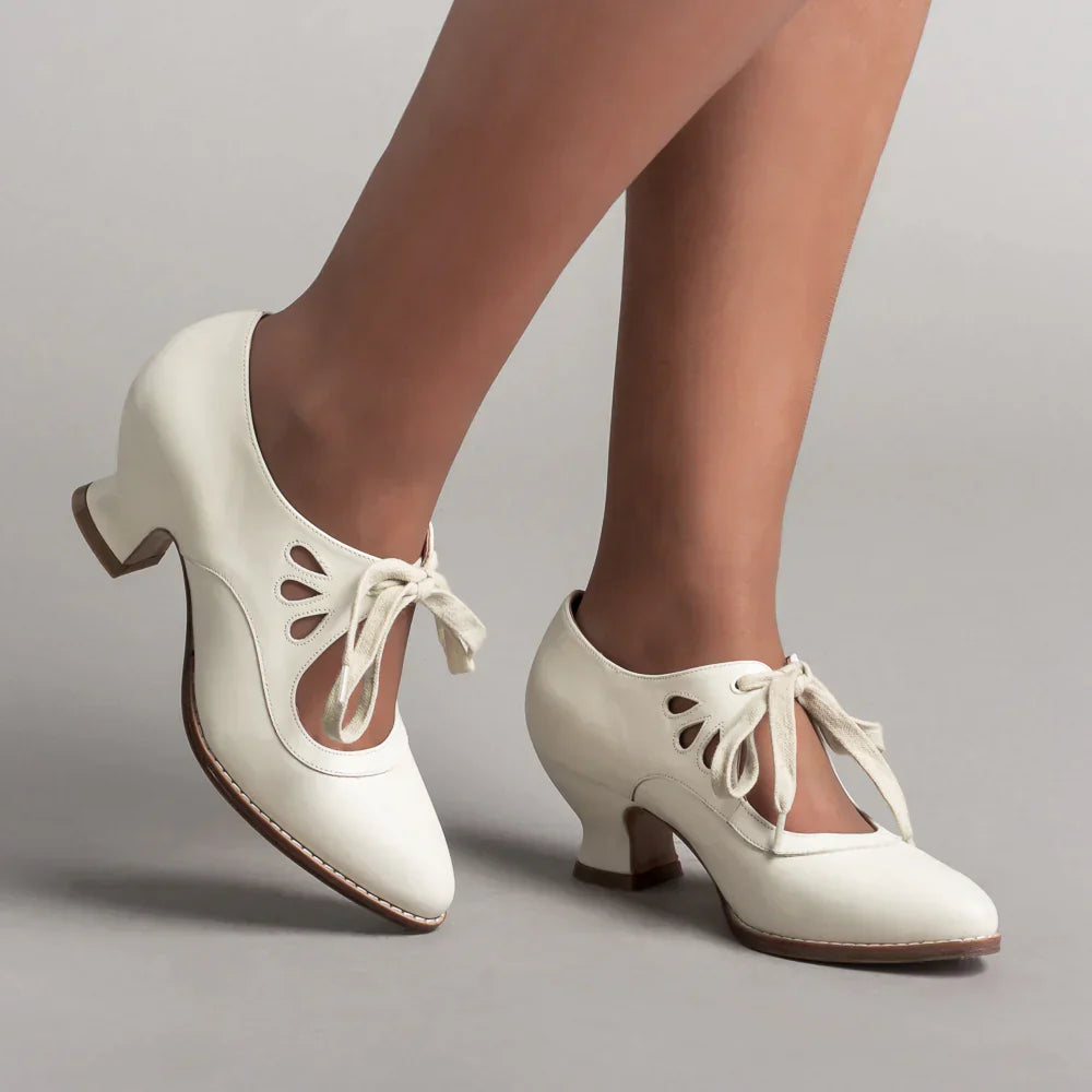Image showing women's vintage heels with a stylish bow tie design and elegant cut-out details, perfect for adding a chic touch to formal or semi-formal outfits.