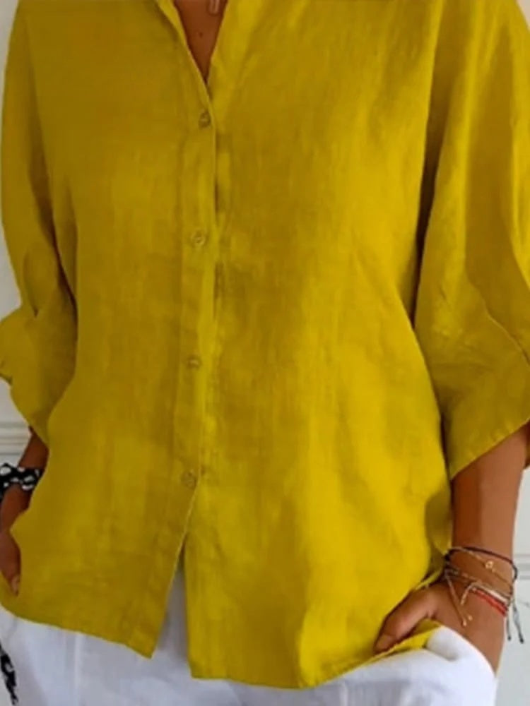 A relaxed-fit women's blouse with a button-up front, long sleeves, and a lightweight, flowy design, styled casually for versatile wear.