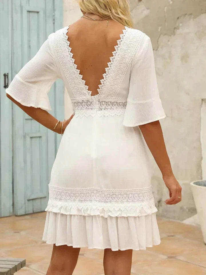 Woman wearing the Grace | Women's Lace Detail Dress | Ruffled Hem Dress, showcasing intricate lace detailing on the bodice and sleeves, with a flattering V-neckline and playful ruffled hem, creating an elegant and feminine look.
