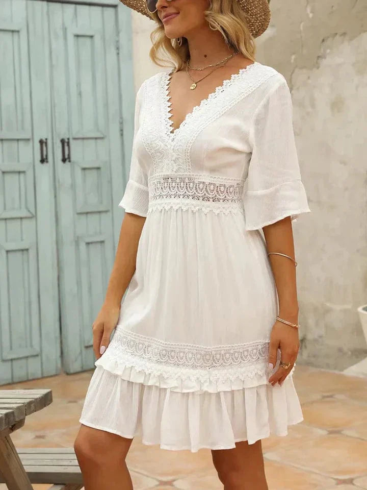 Woman wearing the Grace | Women's Lace Detail Dress | Ruffled Hem Dress, showcasing intricate lace detailing on the bodice and sleeves, with a flattering V-neckline and playful ruffled hem, creating an elegant and feminine look.