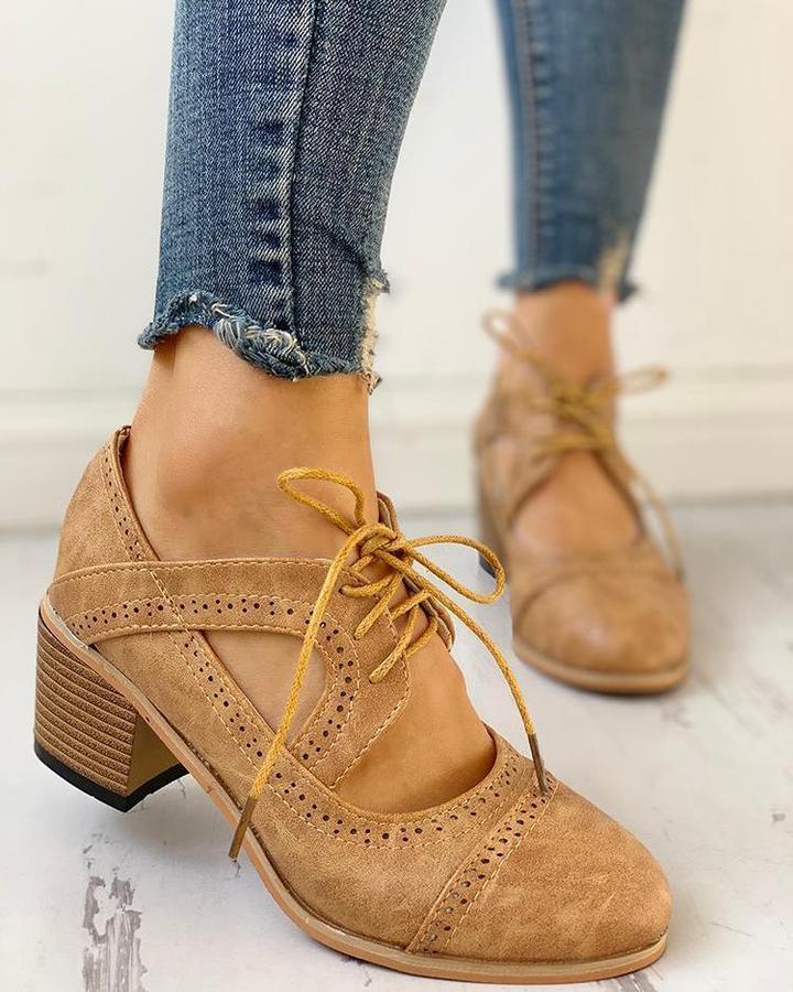 Elegant women's heeled shoes with lace-up detailing and a timeless design, paired with denim pants. Perfect for casual or formal occasions.