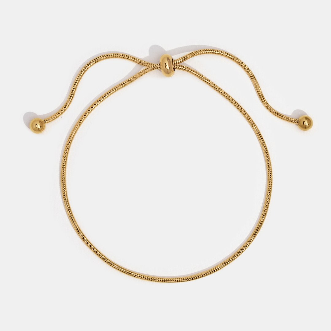 Smiling woman showcasing the Sophia Women's Adjustable Bracelet on her wrist, featuring a sleek and minimalist design. A stylish and versatile accessory perfect for any occasion.