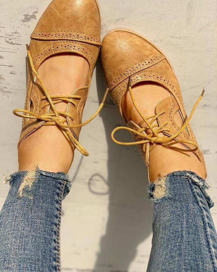 Elegant women's heeled shoes with lace-up detailing and a timeless design, paired with denim pants. Perfect for casual or formal occasions.