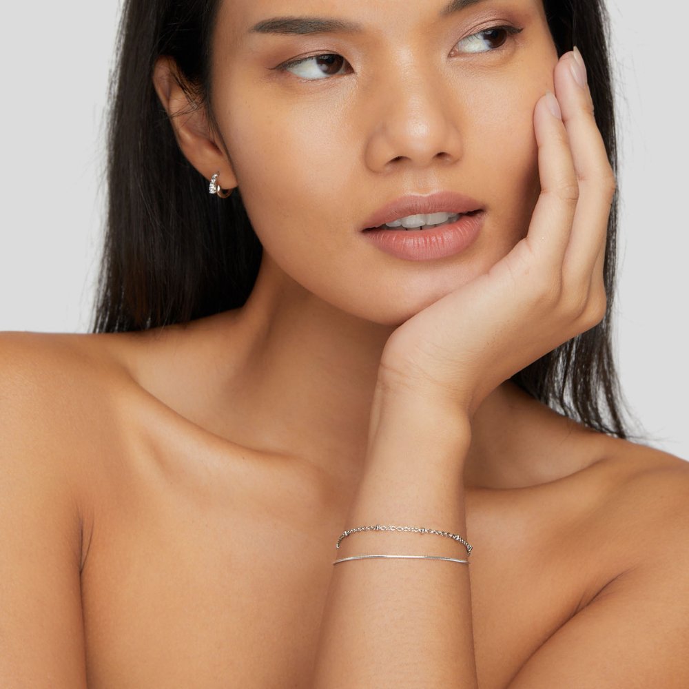 Close-up of the Lily Women's Charm Bracelet showcasing delicate charms and an elegant design, perfect for adding a personalized touch to any outfit. A versatile accessory for various occasions.