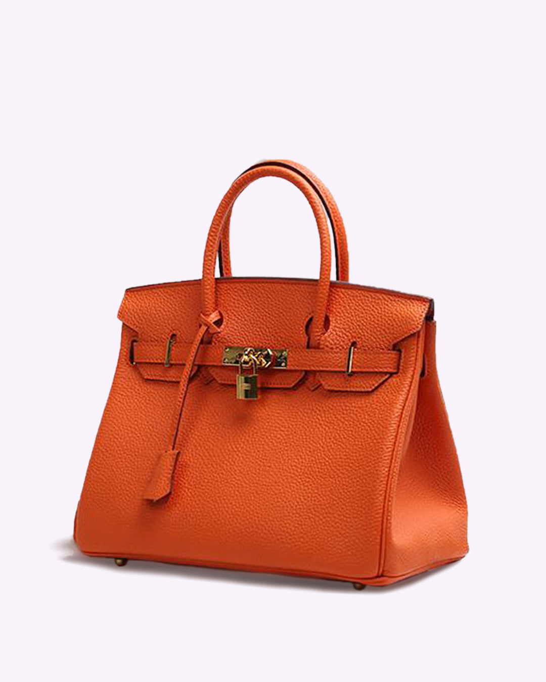 Image showing a woman holding an elegant handbag with a sleek design, featuring gold hardware and a structured shape, paired with casual attire for a stylish, sophisticated look.