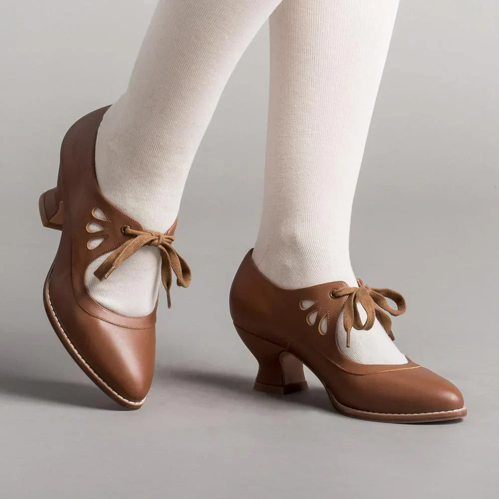 Image showing women's vintage heels with a stylish bow tie design and elegant cut-out details, perfect for adding a chic touch to formal or semi-formal outfits.