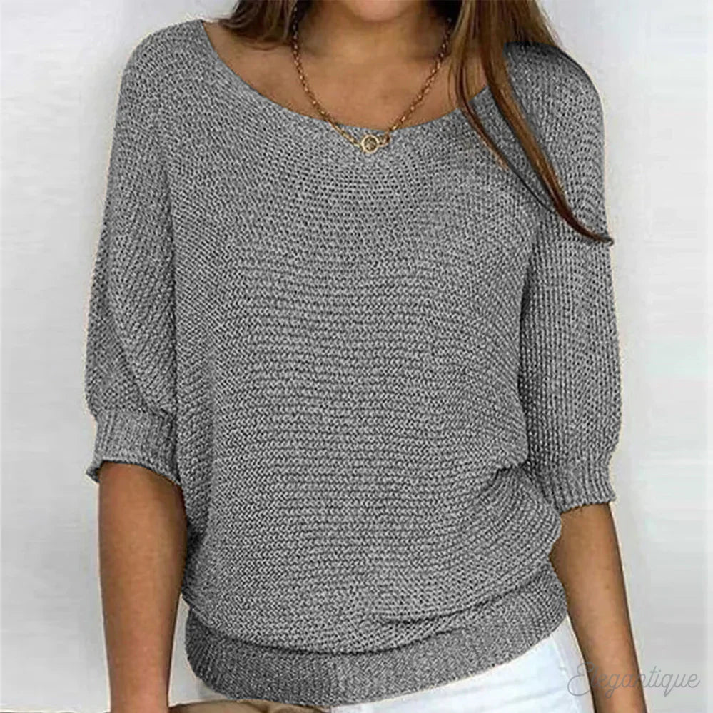 Image of a woman wearing an elegant relaxed fit sweater, featuring a chic design perfect for casual and stylish occasions.