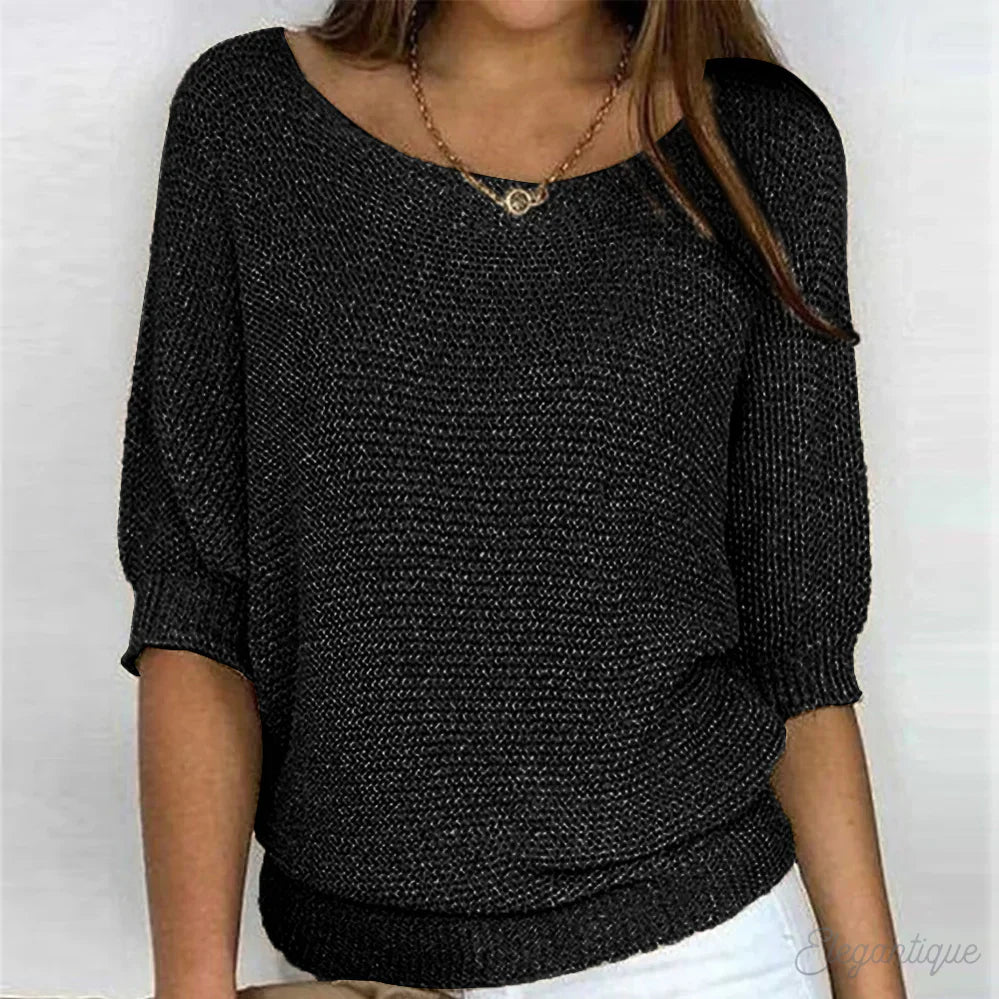 Image of a woman wearing an elegant relaxed fit sweater, featuring a chic design perfect for casual and stylish occasions.