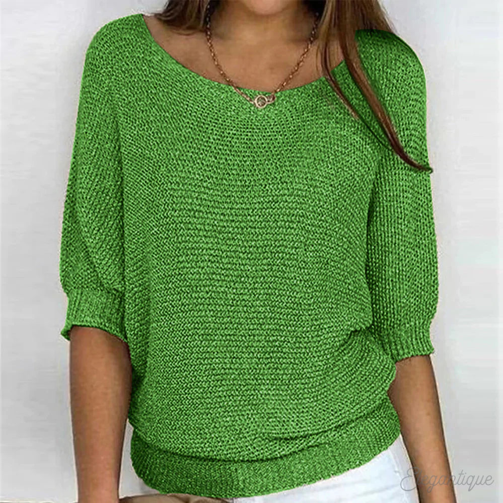 Image of a woman wearing an elegant relaxed fit sweater, featuring a chic design perfect for casual and stylish occasions.