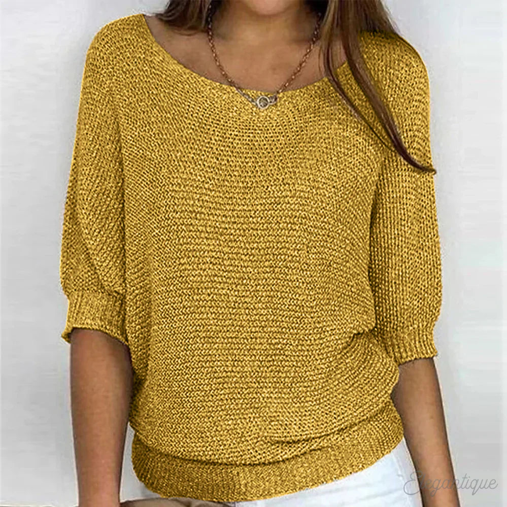 Image of a woman wearing an elegant relaxed fit sweater, featuring a chic design perfect for casual and stylish occasions.