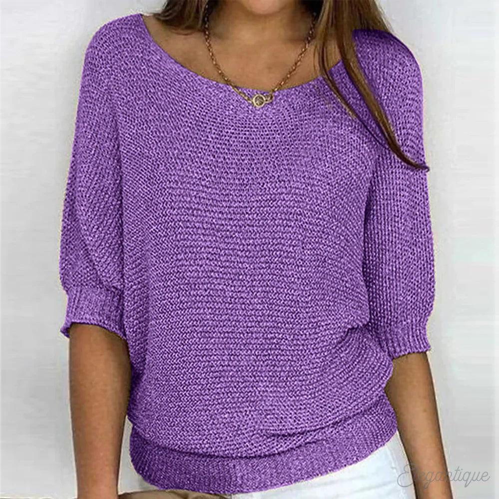 Image of a woman wearing an elegant relaxed fit sweater, featuring a chic design perfect for casual and stylish occasions.