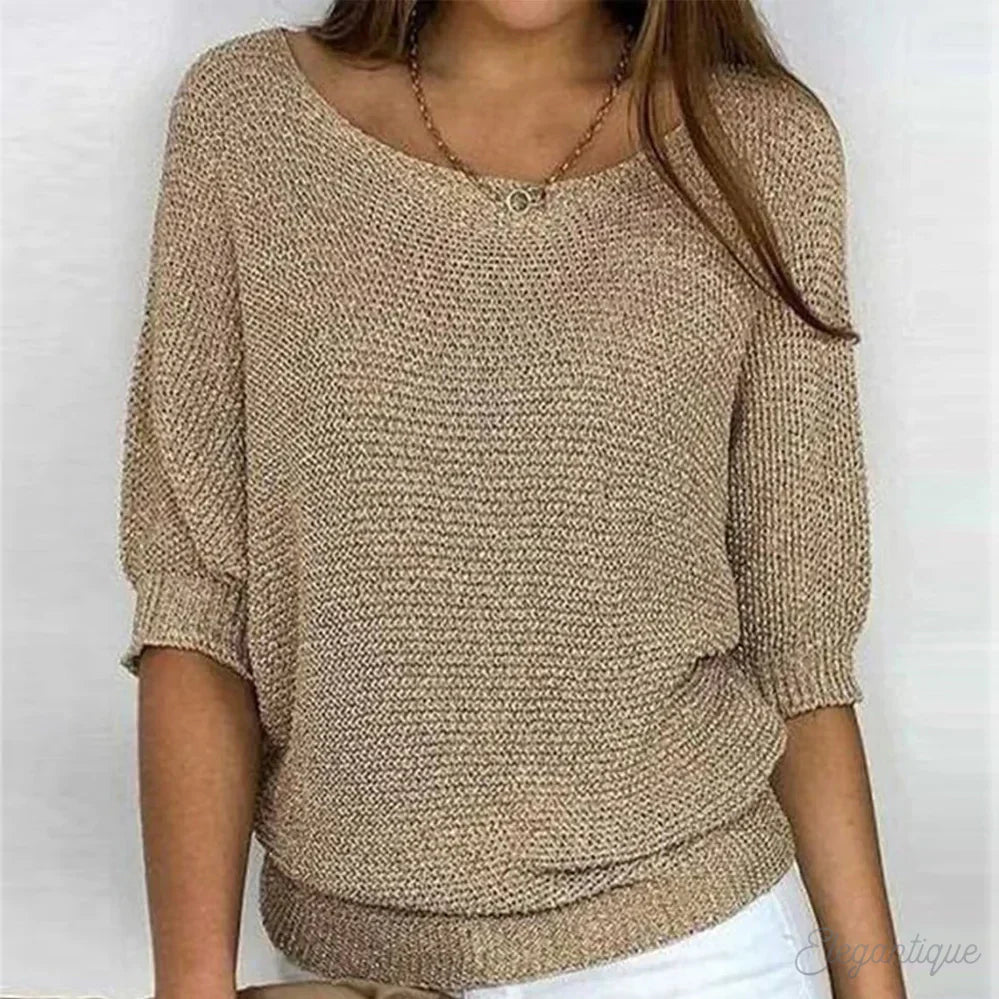 Image of a woman wearing an elegant relaxed fit sweater, featuring a chic design perfect for casual and stylish occasions.