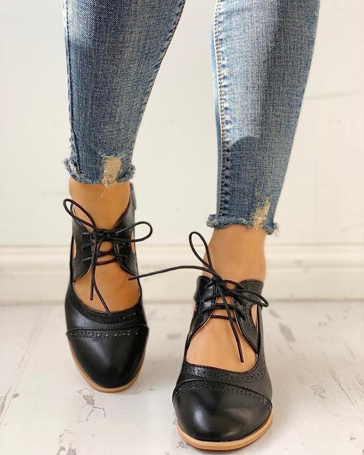 Elegant women's heeled shoes with lace-up detailing and a timeless design, paired with denim pants. Perfect for casual or formal occasions.