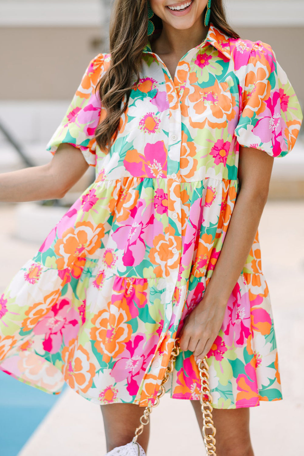 Back view of the Lily Women's Floral Tiered Dress, showcasing a vibrant floral pattern with tiered layers and short puff sleeves.
