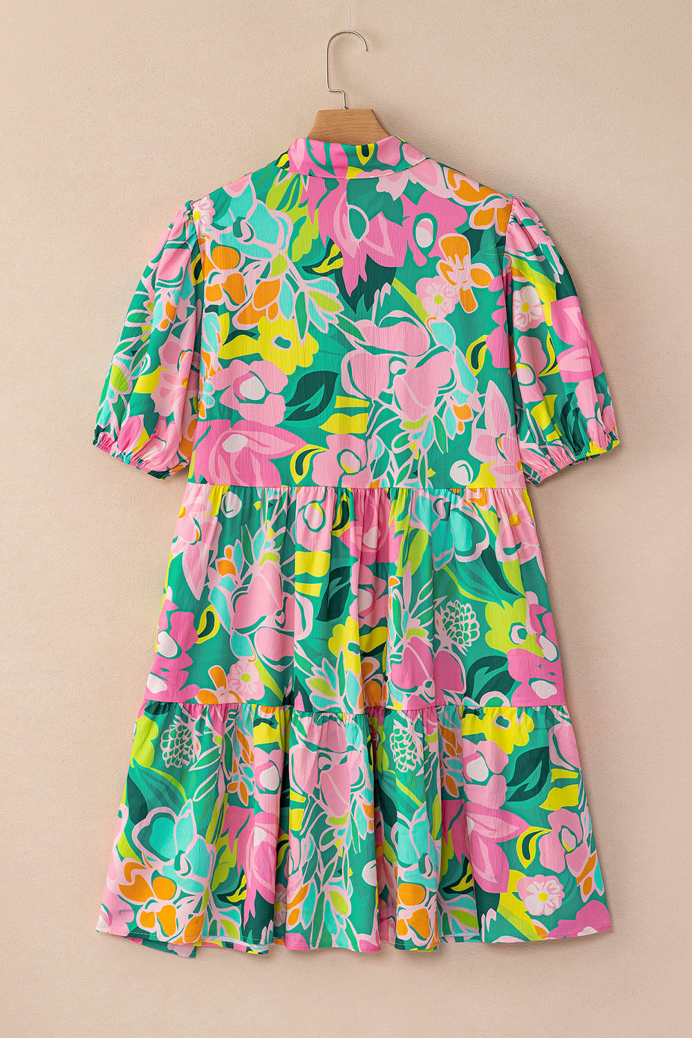 Back view of the Lily Women's Floral Tiered Dress, showcasing a vibrant floral pattern with tiered layers and short puff sleeves.