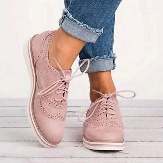 Image showing women's classic sneakers with a stylish brogue design, featuring lace-up closure and a comfortable sole, perfect for casual wear.