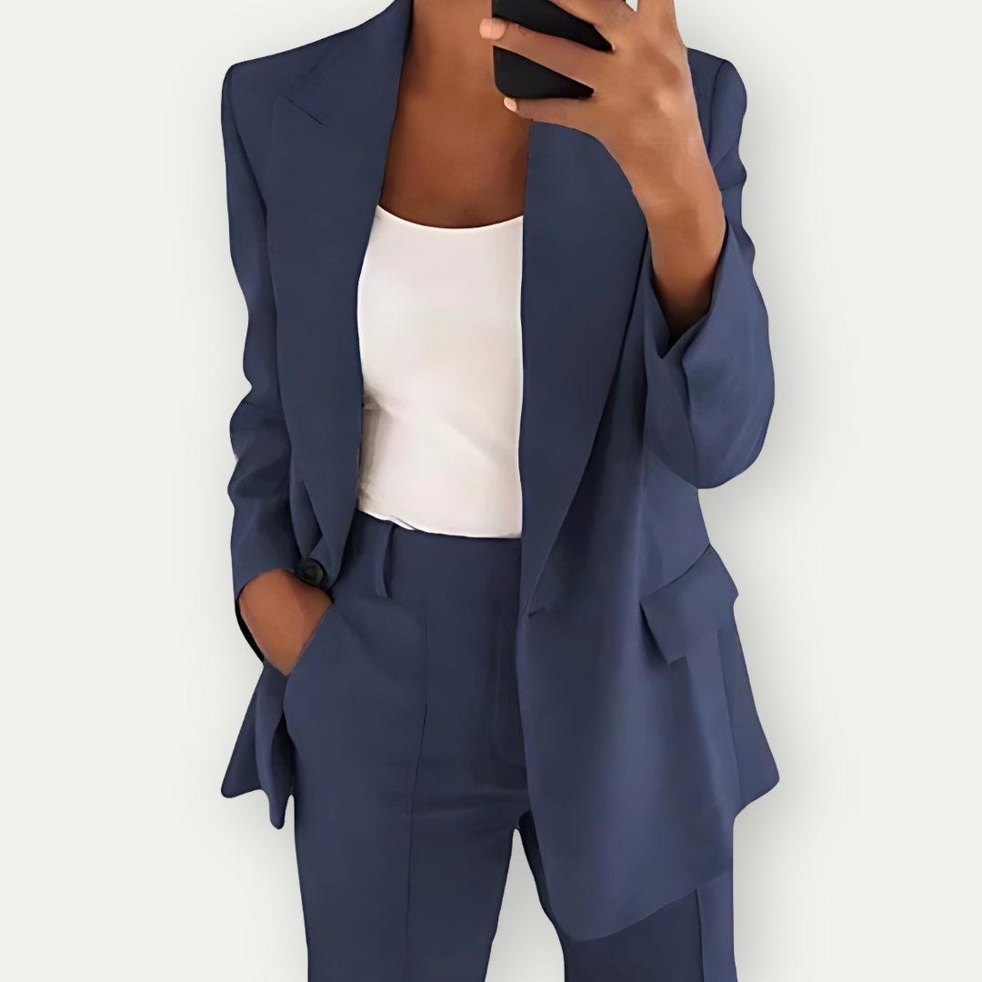 Woman wearing the Samantha Women's Tailored Blazer Set, featuring a fitted blazer with notch lapels and matching tailored pants, paired with a simple top, showcasing a chic and polished look perfect for both professional and casual occasions.