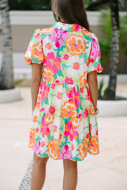 Back view of the Lily Women's Floral Tiered Dress, showcasing a vibrant floral pattern with tiered layers and short puff sleeves.
