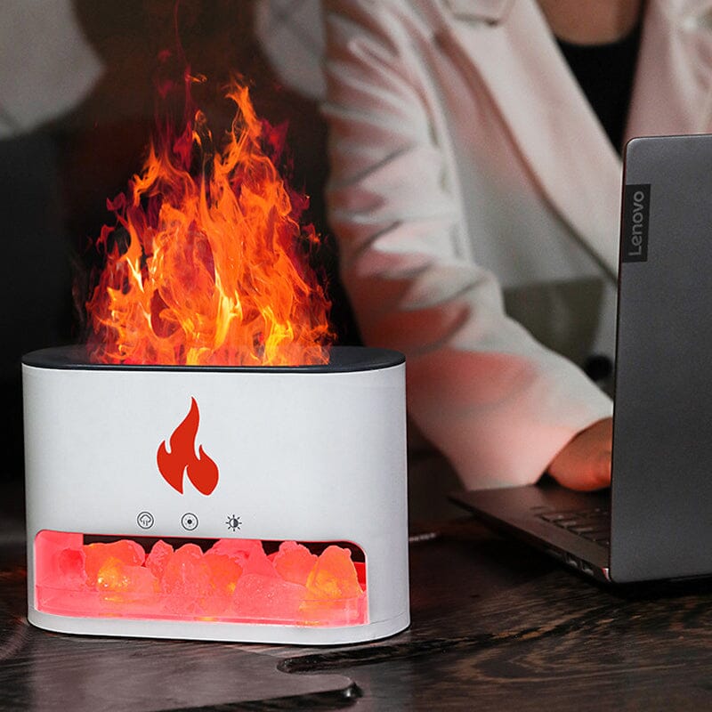 Image showing an aroma diffuser with a sleek design, featuring a button control and a compartment for essential oils, creating a relaxing atmosphere with a flame-like display effect.