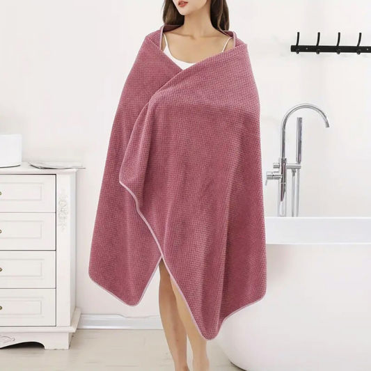 Elegant woman wrapped in an ultra-soft towel, showcasing its luxurious texture and full-body coverage.