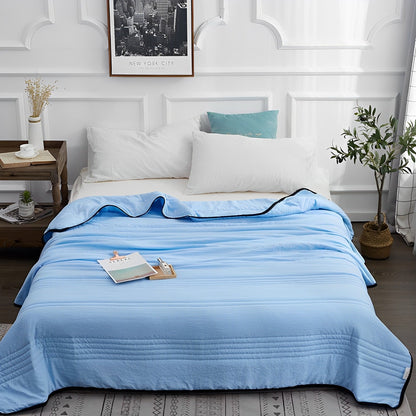 Woman peacefully sleeping wrapped in an ultra-soft blanket, showcasing its cozy and luxurious texture on a neatly made bed.