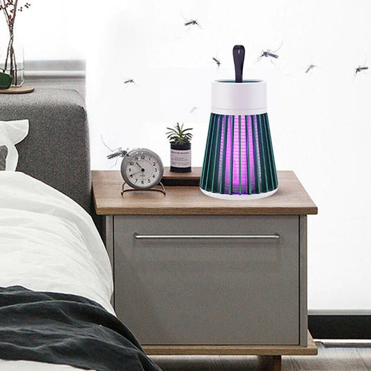 Portable mosquito lamp on a bedside table, emitting a soft glow and showcasing its advanced mosquito-eliminating technology for a peaceful environment.