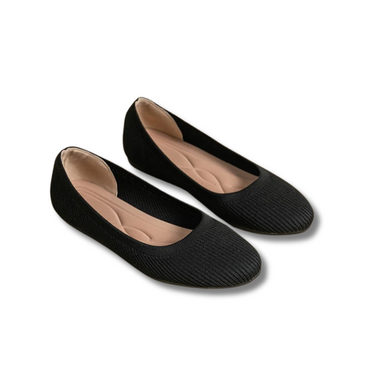 A pair of women's comfortable flat shoes designed with a ribbed texture and cushioned insoles, perfect for everyday wear.