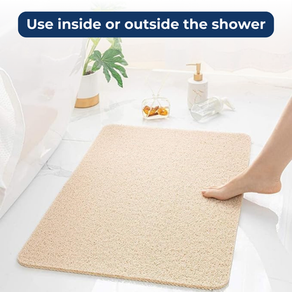  A bathroom anti-slip mat placed near a shower with a person stepping onto it, featuring a quick-dry design and textured surface for enhanced grip and safety.