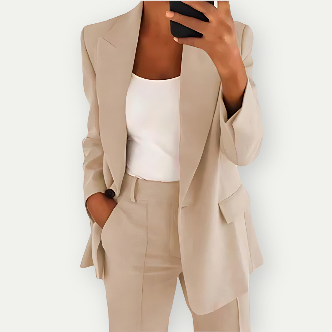 Woman wearing the Samantha Women's Tailored Blazer Set, featuring a fitted blazer with notch lapels and matching tailored pants, paired with a simple top, showcasing a chic and polished look perfect for both professional and casual occasions.