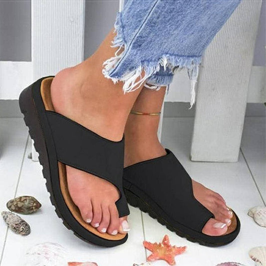 Stylish women's sandals with a comfortable fit, designed for casual wear and summer outings, paired with white pants for a chic look.