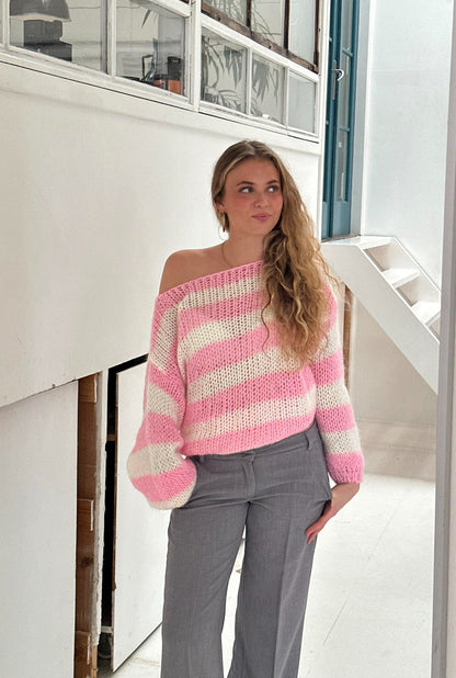 Model wearing the Sophia | Striped Knit Sweater, featuring bold stripes and a cozy, relaxed fit. Perfect for layering or wearing on its own, this sweater adds a touch of casual style to any outfit while keeping you warm and comfortable.